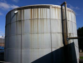Large sprinkler tank with corrosion at water line 