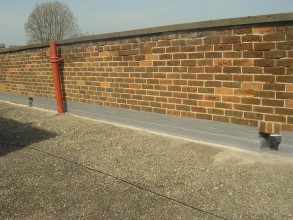 Sealed flashing at parapet wall resulting in long-term roof protection